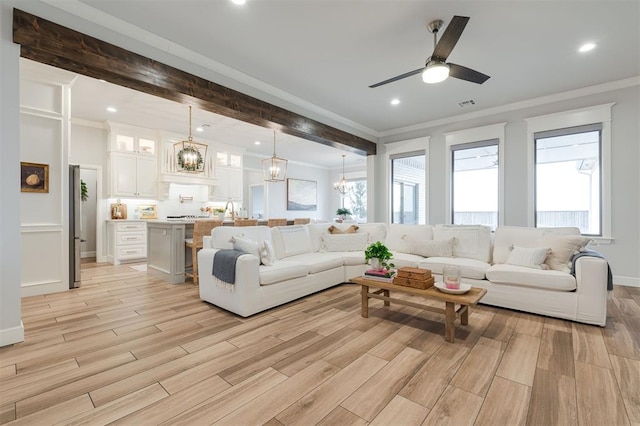 living area featuring wood finish floors, recessed lighting, visible vents, ornamental molding, and beamed ceiling