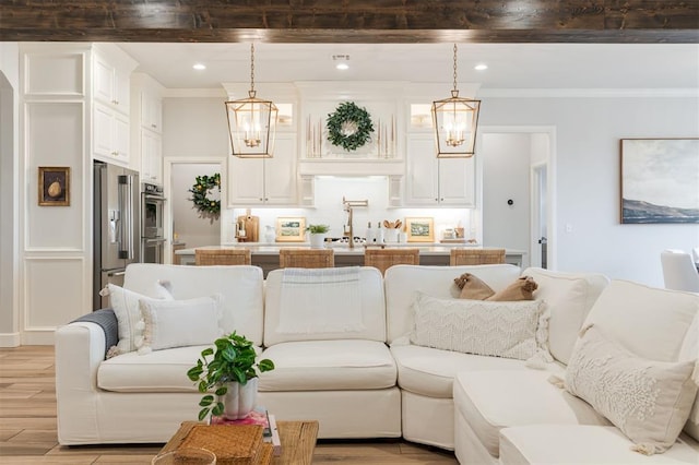 living room featuring light wood-style floors, recessed lighting, and ornamental molding