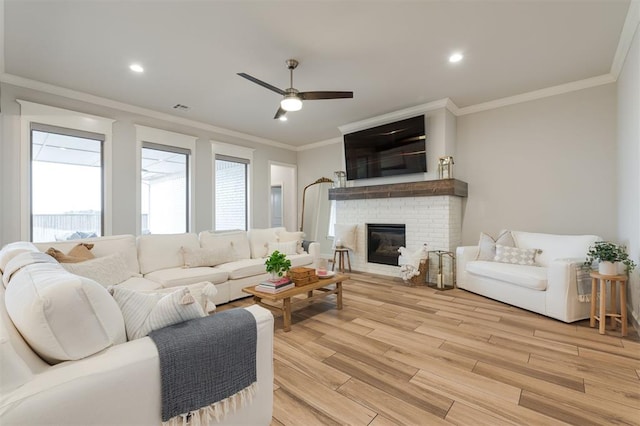 5616 Windstone Dr, Norman, OK 73072 - living area with ceiling fan, visible vents, crown molding, a brick fireplace, and light wood finished floors