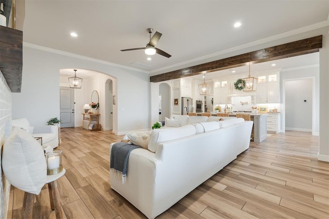 5616 Windstone Dr, Norman, OK 73072 - living area with light wood-style floors, arched walkways, ceiling fan, and recessed lighting