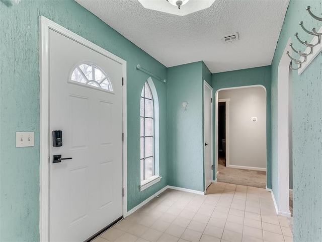 foyer featuring a textured ceiling