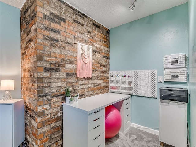 unfurnished office featuring a textured ceiling and carpet flooring