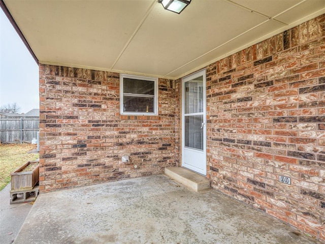 view of exterior entry featuring a patio