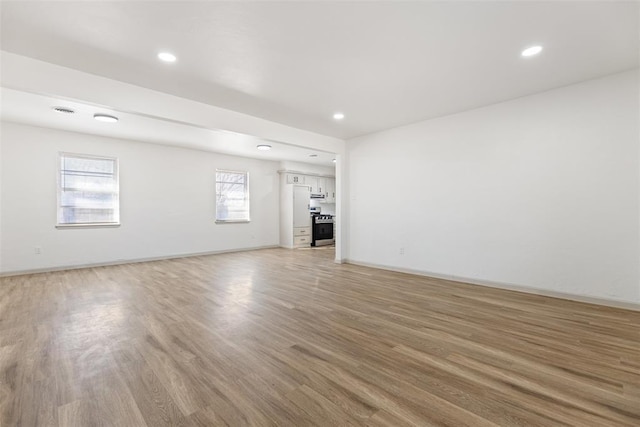 unfurnished living room featuring hardwood / wood-style flooring