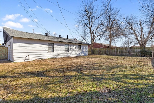 rear view of property with a lawn