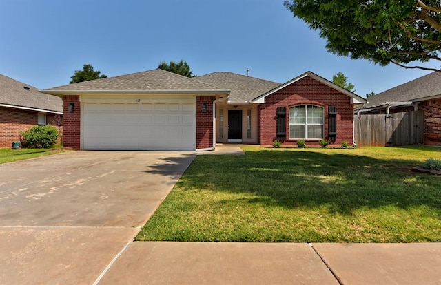 ranch-style home with a garage and a front lawn