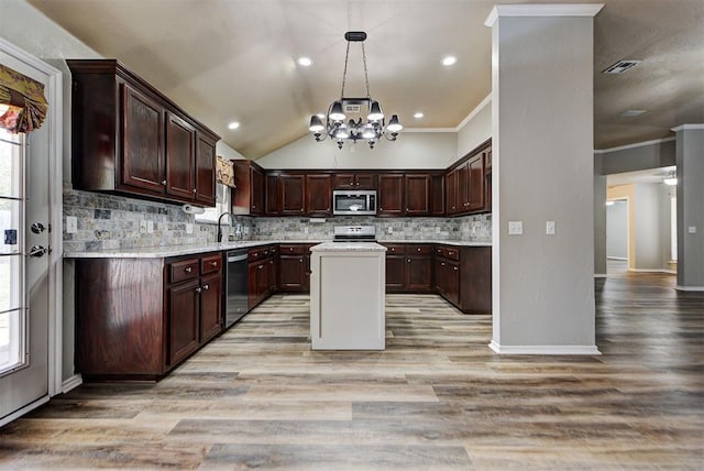 kitchen with dark brown cabinetry, sink, pendant lighting, stainless steel appliances, and backsplash