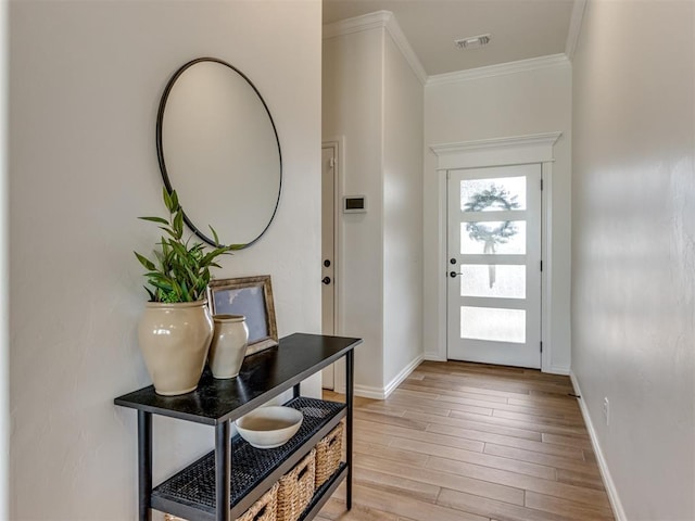 doorway featuring crown molding and light hardwood / wood-style flooring