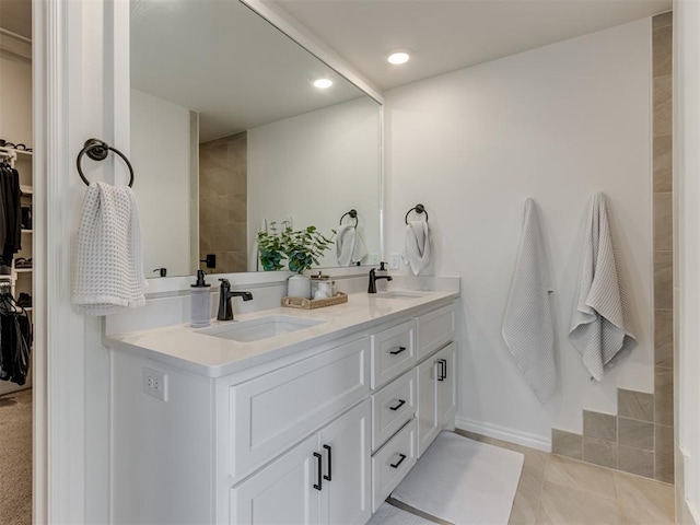 bathroom featuring tile patterned flooring and vanity