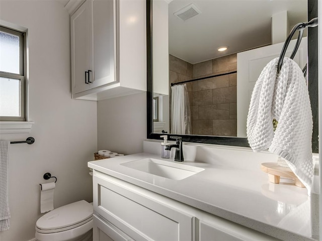 bathroom featuring toilet, vanity, and a shower with shower curtain