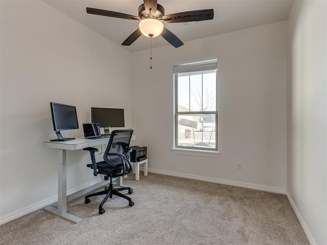 office space with ceiling fan and light carpet