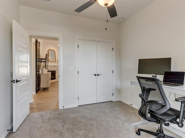 office with light carpet and ceiling fan