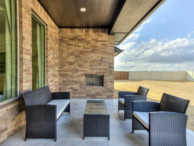 view of patio featuring an outdoor living space with a fireplace