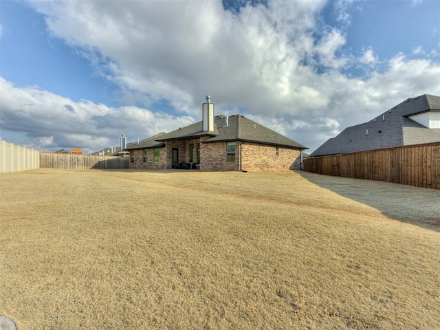 rear view of house featuring a lawn