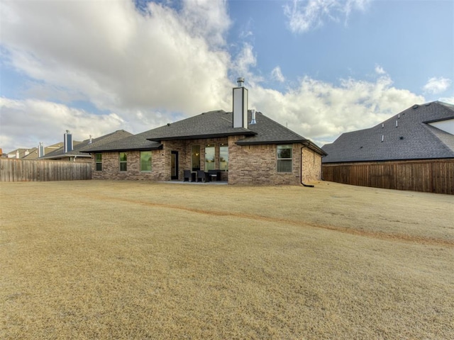 rear view of house with a yard