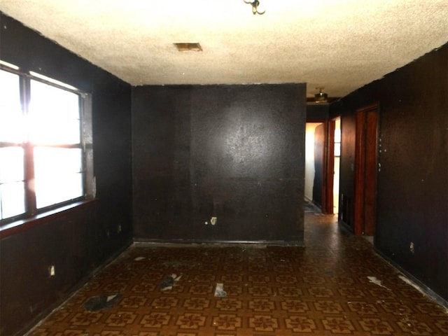 spare room with a textured ceiling