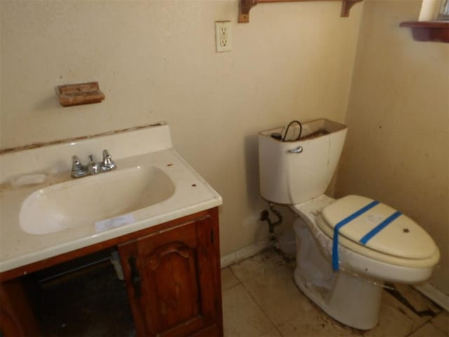 bathroom with vanity, tile patterned floors, and toilet