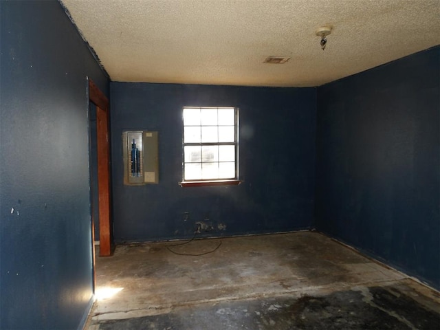 unfurnished room featuring a textured ceiling