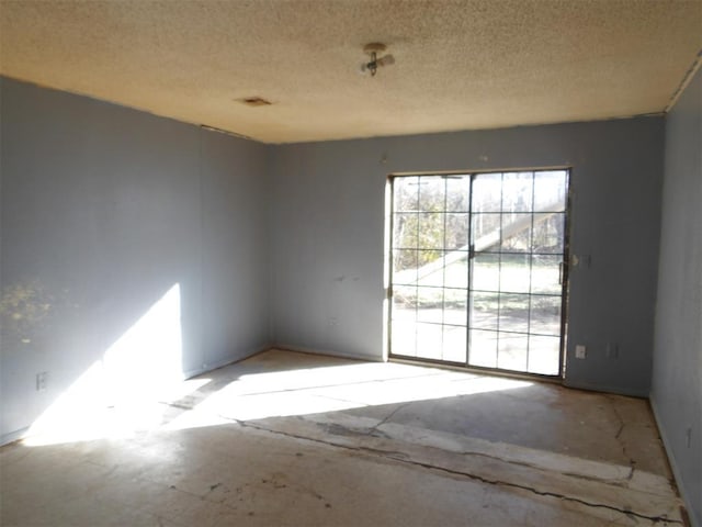 empty room featuring a textured ceiling