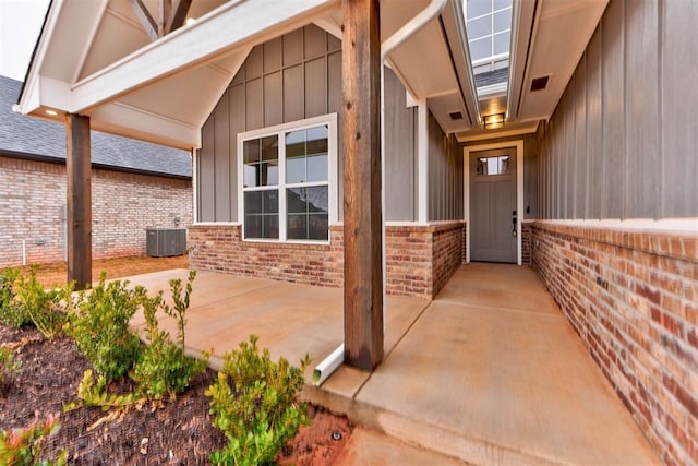 doorway to property with a patio and central AC unit