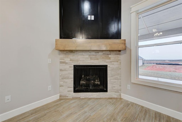 interior details with hardwood / wood-style floors and a tile fireplace