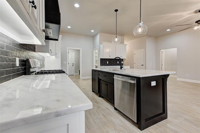 kitchen featuring sink, range, stainless steel dishwasher, a kitchen island with sink, and white cabinets