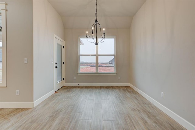 unfurnished dining area with light hardwood / wood-style flooring and a chandelier