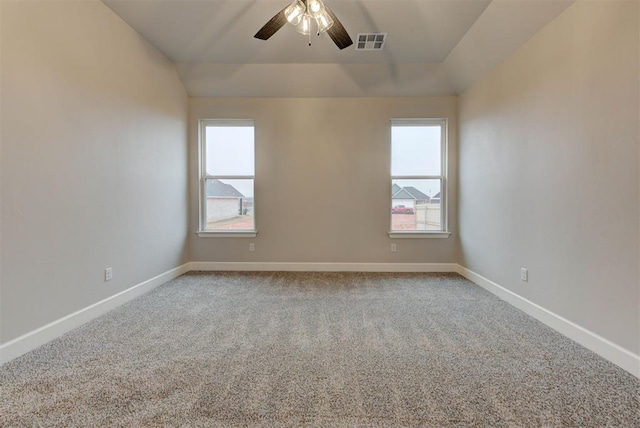 spare room with ceiling fan, lofted ceiling, and carpet