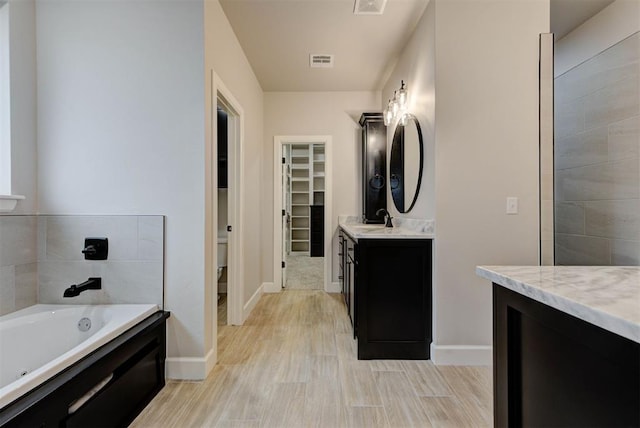 bathroom featuring vanity, hardwood / wood-style floors, and toilet