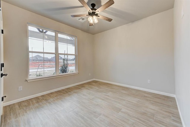 empty room featuring ceiling fan and light hardwood / wood-style floors