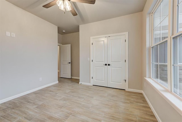 unfurnished bedroom featuring a closet, ceiling fan, and light wood-type flooring