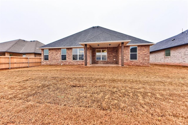 rear view of house with a yard