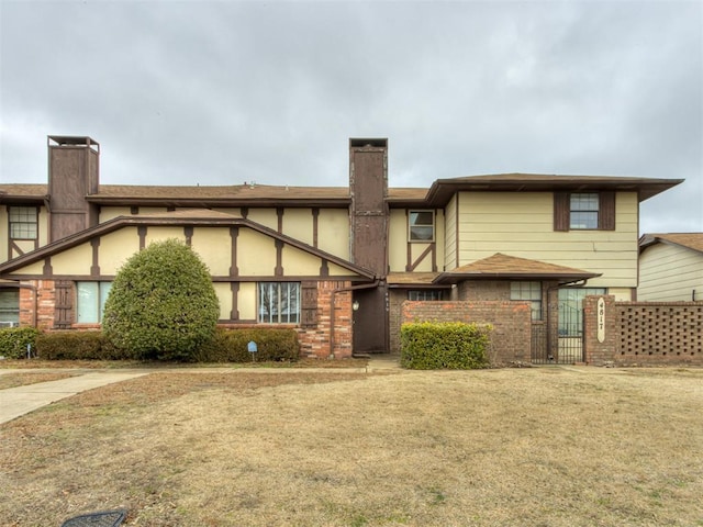 rear view of property with a yard