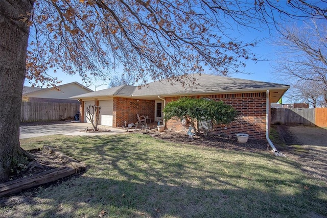 back of house featuring a garage and a lawn