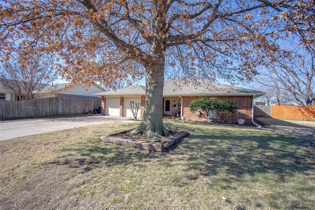 ranch-style house featuring a garage and a front lawn