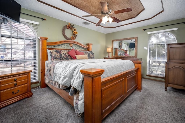 bedroom with ceiling fan, carpet flooring, and a textured ceiling