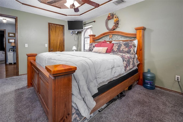 bedroom with ceiling fan, dark carpet, and a textured ceiling