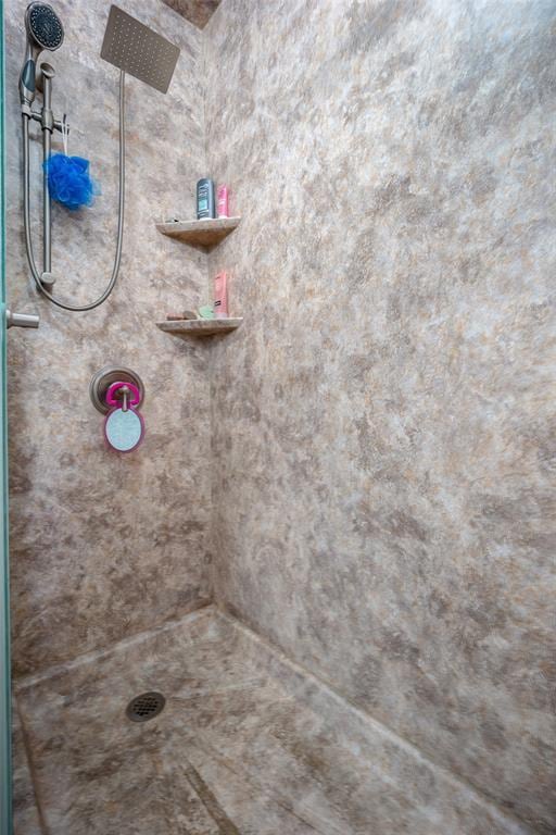 bathroom with tiled shower