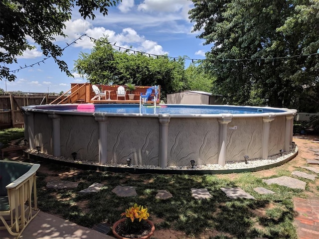 view of pool with a storage unit