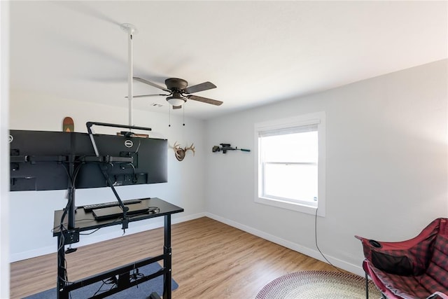 office featuring a ceiling fan, baseboards, and wood finished floors