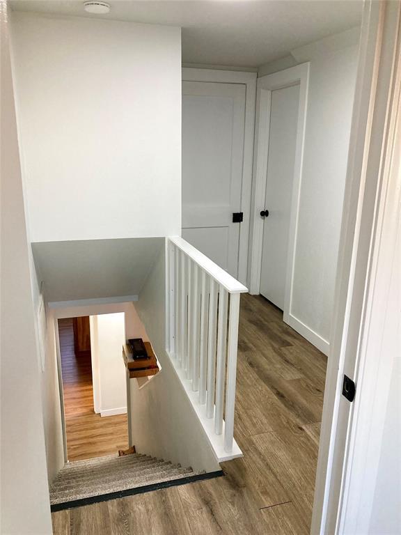 staircase featuring wood finished floors