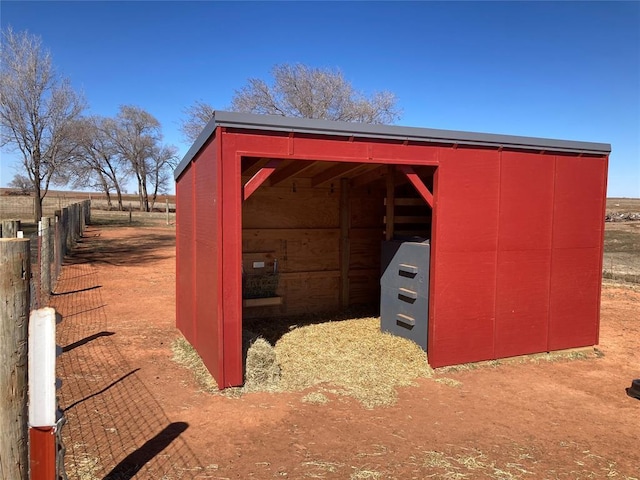 view of pole building featuring fence