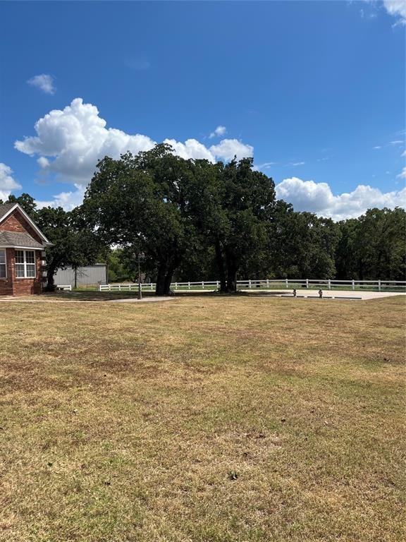 view of yard with a rural view