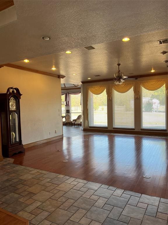 unfurnished living room featuring wood-type flooring and a textured ceiling