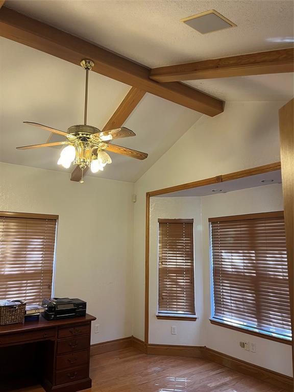 office area with vaulted ceiling with beams, hardwood / wood-style floors, a textured ceiling, and ceiling fan