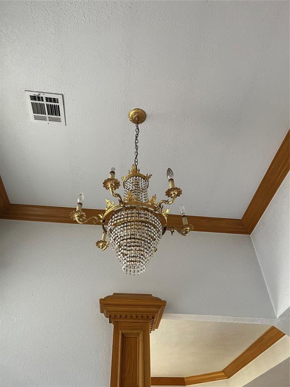 interior details featuring a chandelier