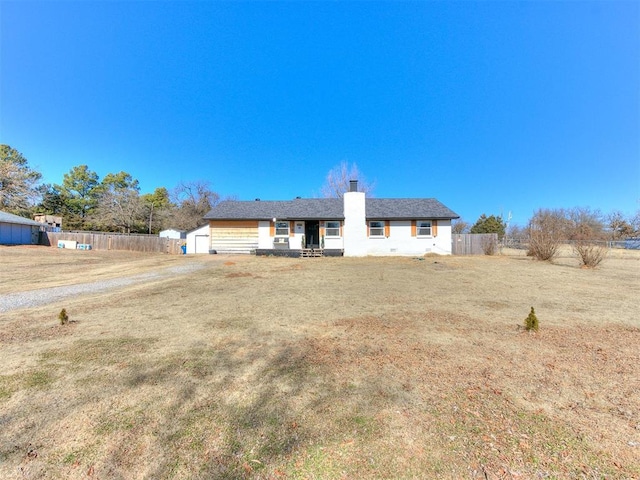 rear view of house with a yard and a garage