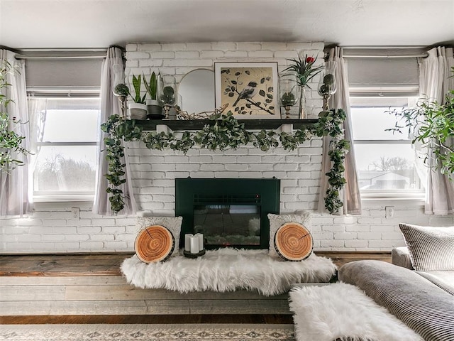 interior details with hardwood / wood-style flooring and a brick fireplace