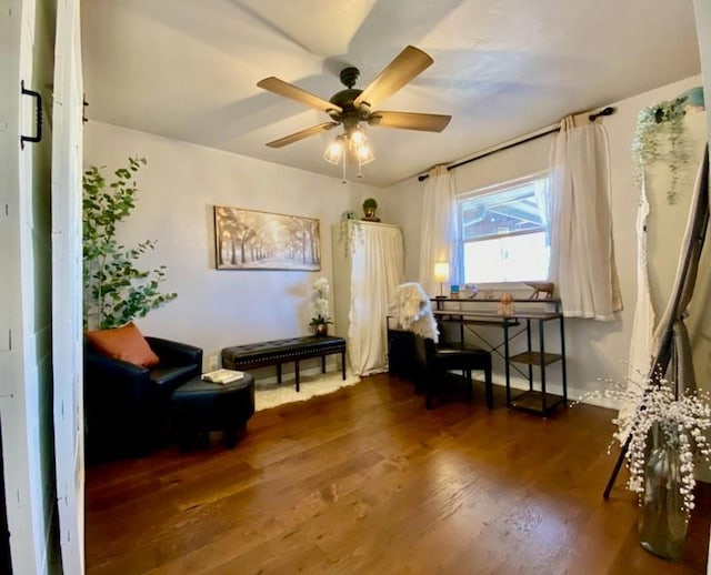 living area with ceiling fan and dark hardwood / wood-style flooring