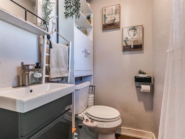 bathroom featuring vanity and toilet